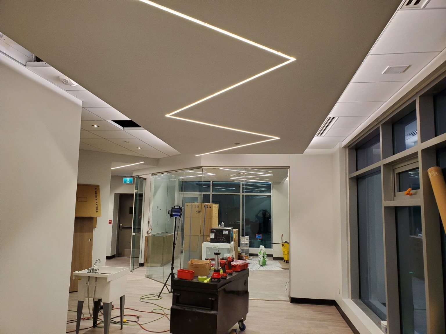 Zigzag linear ceiling lighting in a commercial interior during construction